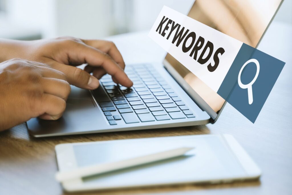 Laptop with keywords highlighted in front of the screen