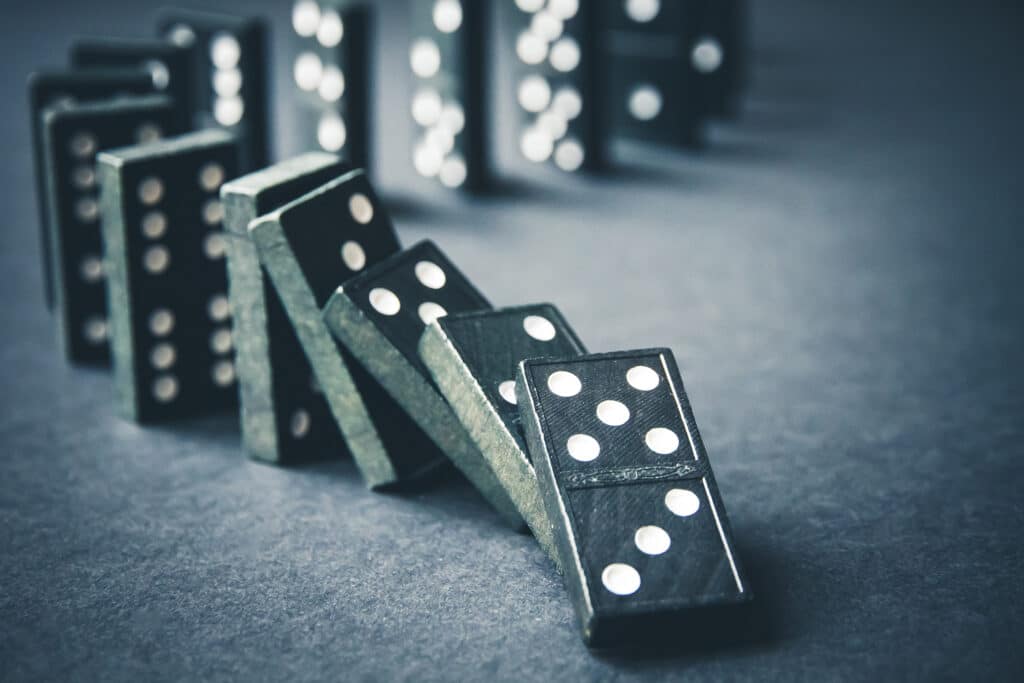 dominoes representing the risk of relying on interconnected networks for users and advertisers