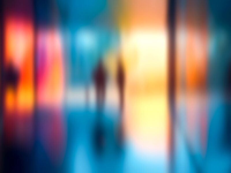 Blurred people of different demographics in abstract gradient colours