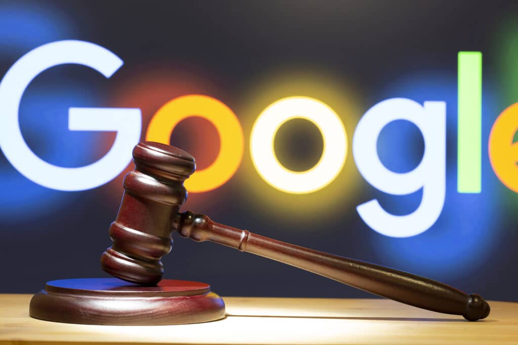 A hammer with Google logo in the background