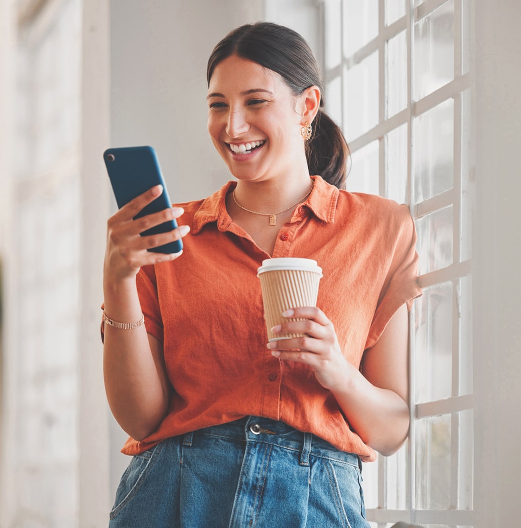 woman seeing organic social media marketing on her phone with a coffee in hand