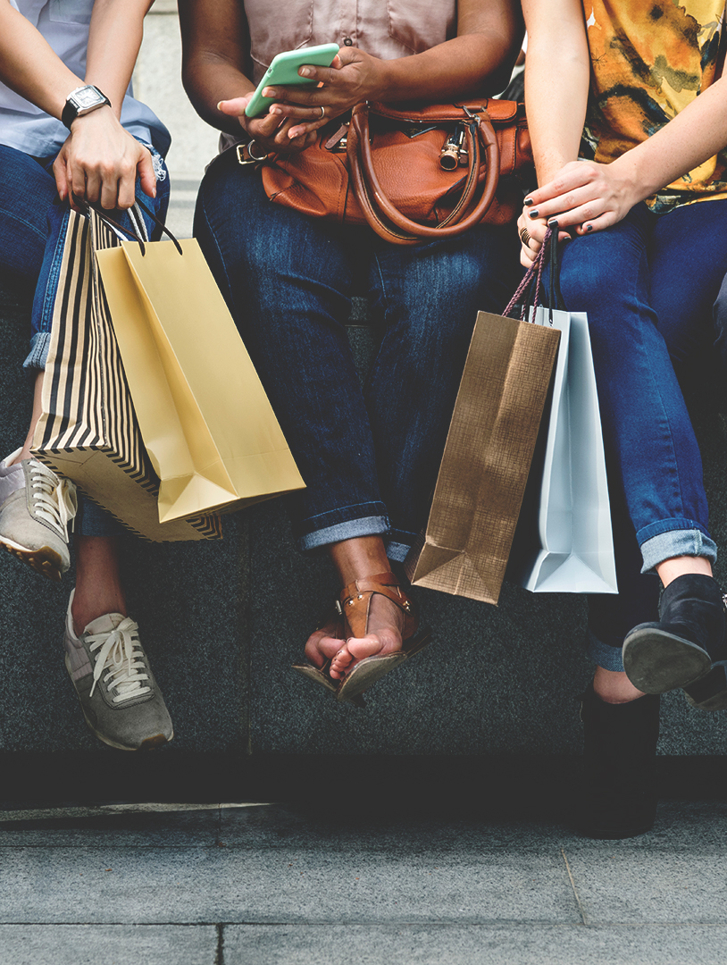 three people with shopping bags as a metaphor for ecommerce online shopping