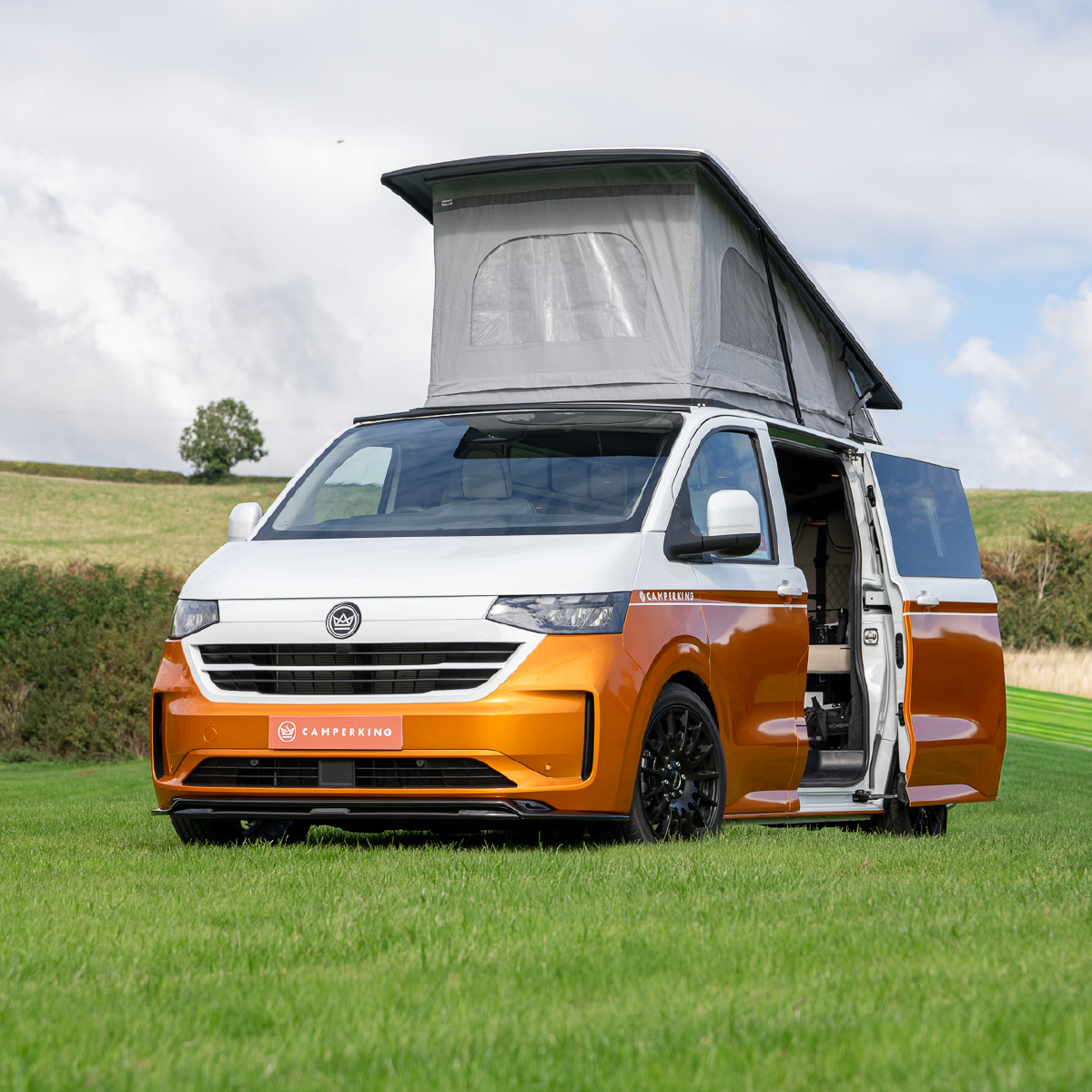 A camperking built VW T7 campervan conversion parked in a field