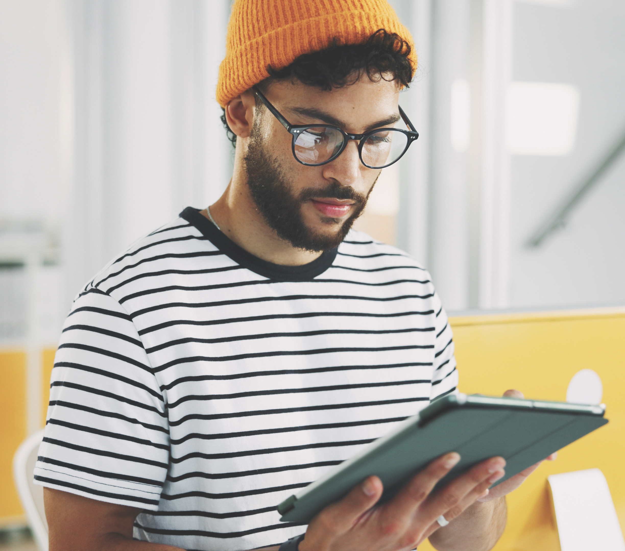 man using tablet to check emails and being served email marketing