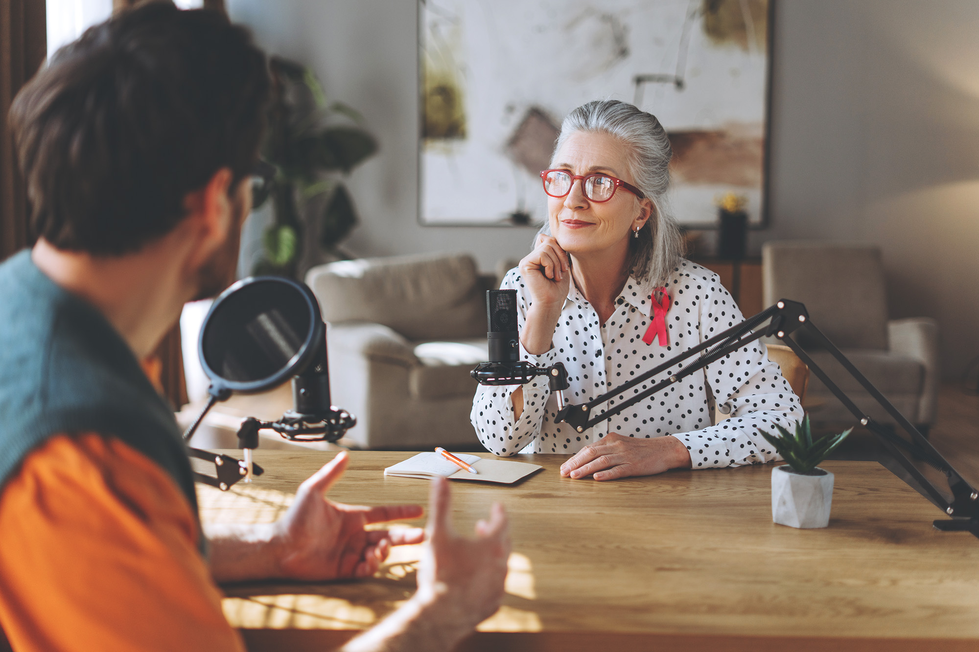 woman being interviewed with microphones on the table for digital PR