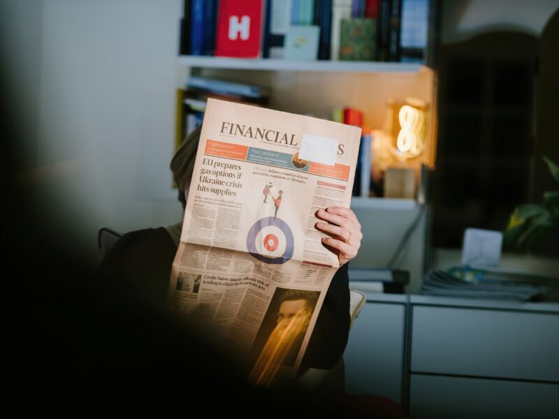 Person reading newspaper broadsheet